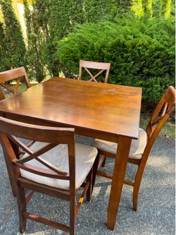Square wooden high table and four chairs