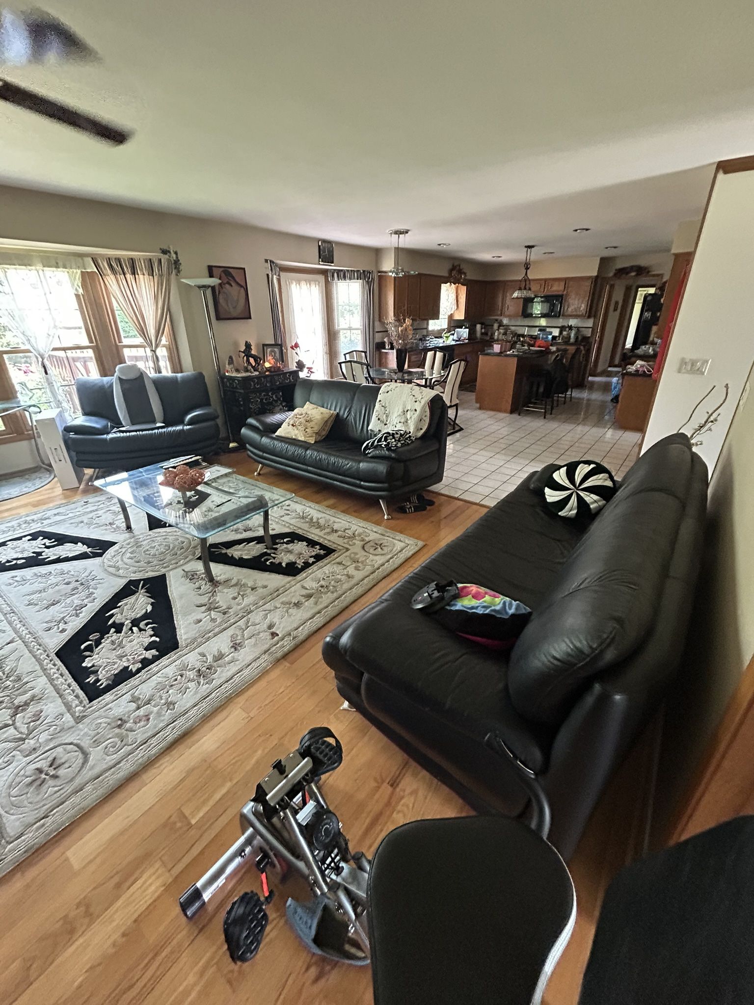 Three leather couches and the glass table