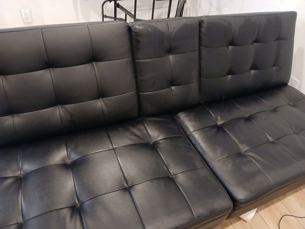 Futon- clean and lays flat to sleep on