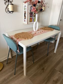 White Dining Table with Two Teal Chairs