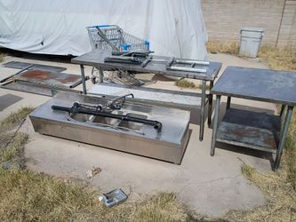 A couple stainless steel tables and sinks