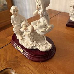 Guiseppe Armani boy and girl on a see saw