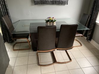 Dining room table with 4 chairs and has storage on bottom