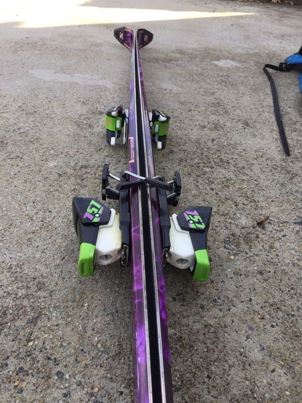 Downhill skis with poles and bag