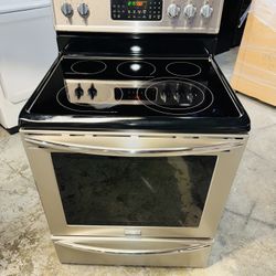 Frigidaire stainless steel electric stove with a receipt for a 90-day warranty