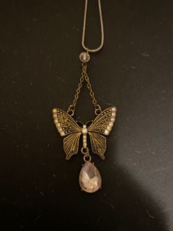 Beautiful butterfly necklace with crystals alongside the wings and quartz crystal at end of butterfly!!Beautiful !!