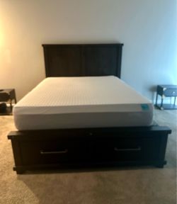 Black wood queen size bed frame and mattress.