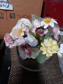 Porcelain flowers and glass round vase.