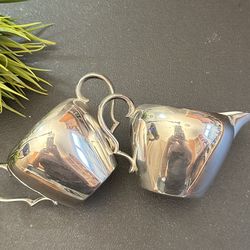 Elegant silver coated creamer and sugar bowl set.