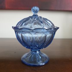 Blue pressed glass covered dish in the Anchor Hocking Fairfield pattern.