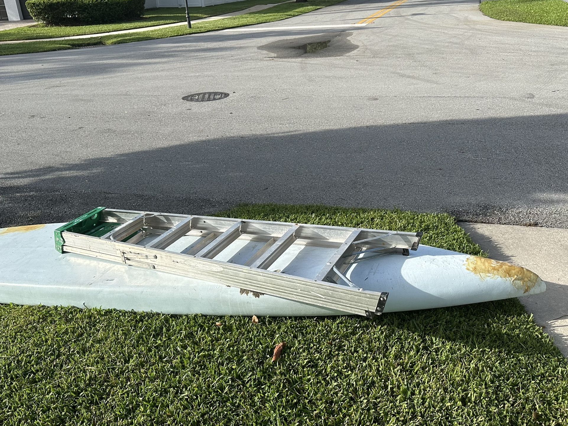 Free ladder and Fiberglass Paddle board no leaks for Sale in Fort