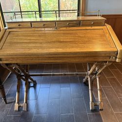 vintage campaign-style desk with faux bamboo legs.