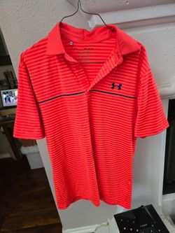 This Under Armour Men's Playoff 2.0 Golf Polo is featured in a vibrant orange and blue striped design