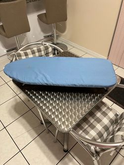 Small, portable ironing board in good condition; it measures 31 inches long and 12 inches wide.