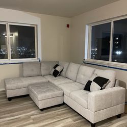 Light Grey Sofa With Ottoman And Pillows