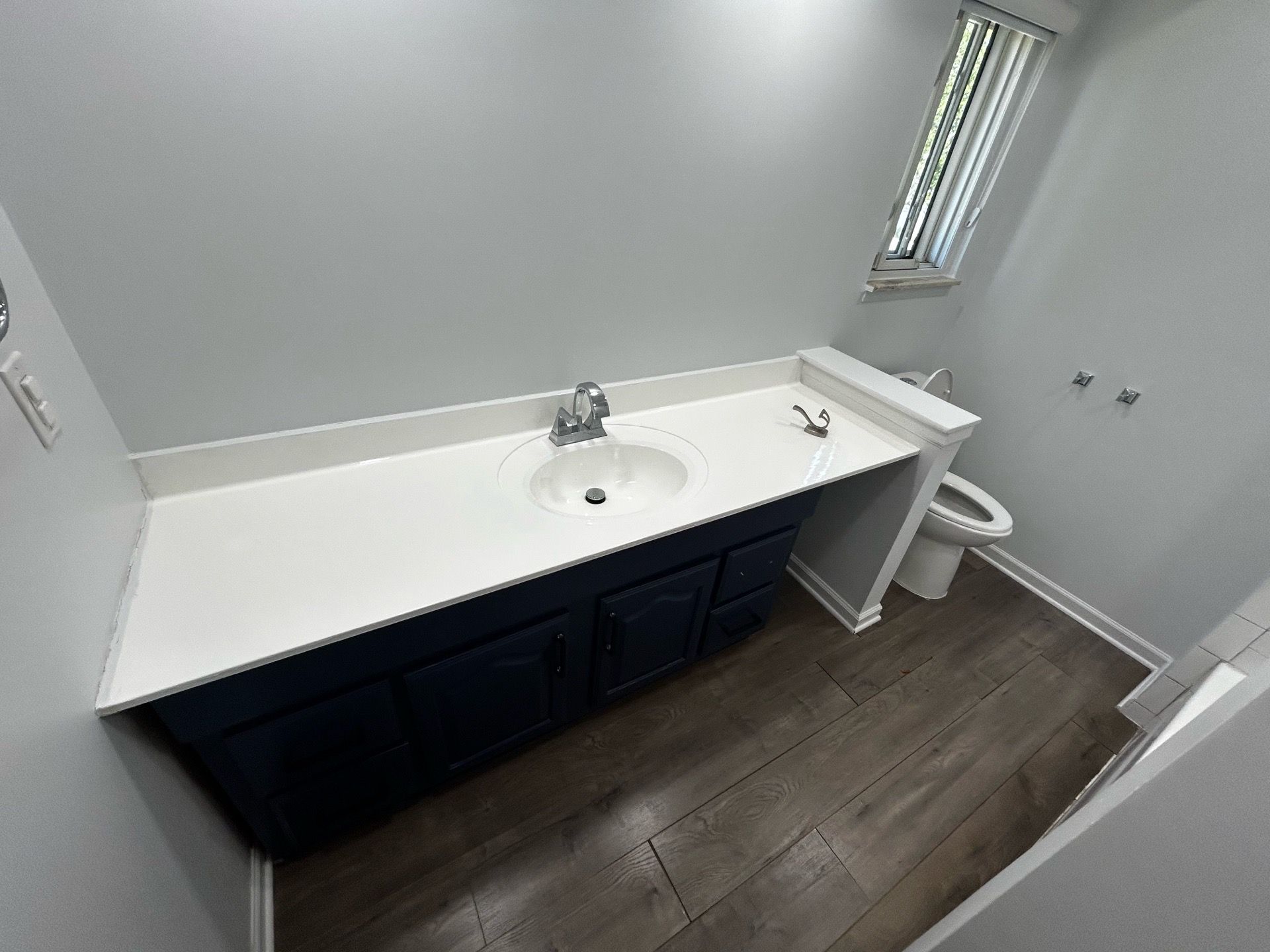 Navy Blue Bathroom Vanity with White Countertop and Sink and toilet (disassembled)