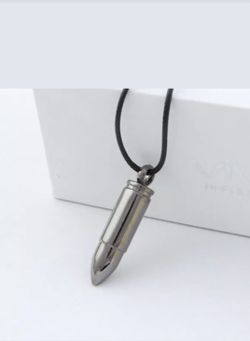 Bullet pendant on leather necklace.
