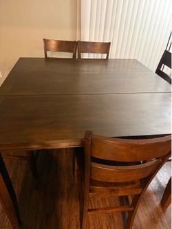 Brown wood dinner table with 6 chairs
