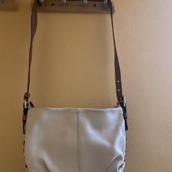 Coach leather shoulder bag with adjustable strap.