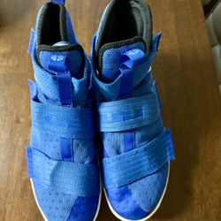 Blue Cross and white Nike basketball shoe size 10.5