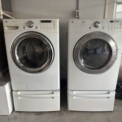 Front-Load LG Washer/Dryer Set On Pedestals
