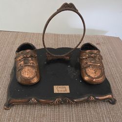 Photo frame with base, vintage style from the 1960s, featuring a bronze-plated baby shoe design. 9"W x 7"D x 5"H