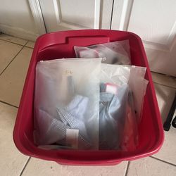 Box Full Of Packaged, Unused Baby Clothes