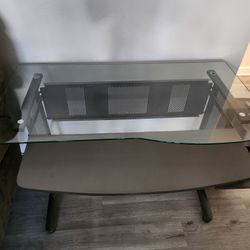 Glass top desk with pull out keyboard tray and elevated side shelf