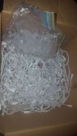 a box of white lights with hanging gear $10