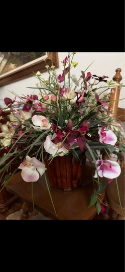 artificial orchid centerpiece  mix of pink and burgundy  in a rustic wooden planter