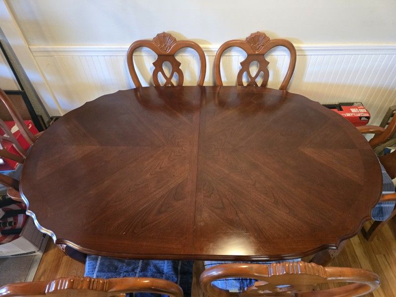 Dining room table with 2 captains chairs and 4 matching chairs also China cabinet in package