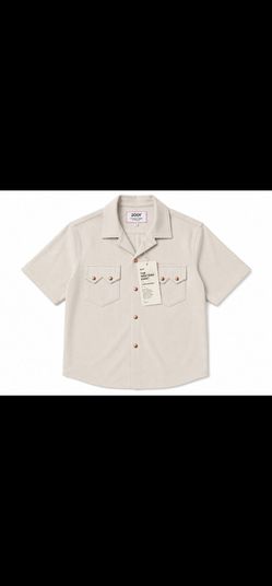 Men’s Columbia short-sleeve button-front shirt in a clean off-white/cream color. Features a classic collared design, button-front closure, chest pocke
