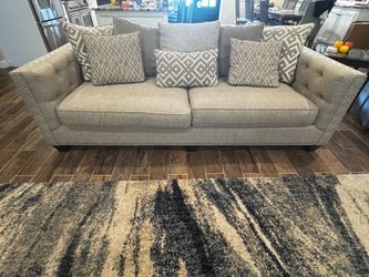 Gray Tufted Sofa with Nailhead Trim