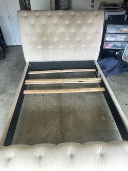 Queen sized beige upholstered bed