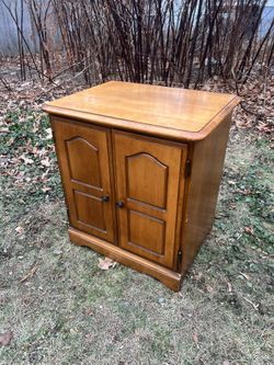 mid-century walnut open-shelf nightstand.