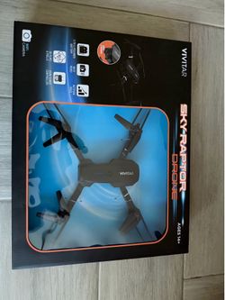 New Vivitar Sky-Raptor quad-copter drone is black with a built-in Wi-Fi camera. This folding drone has a 3.7V Li-polymer battery and an icon-coded joy