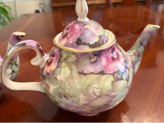Floral teapot with matching cup and saucer