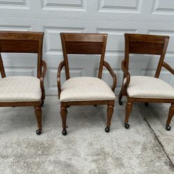 3 Rolling Oak Chairs.