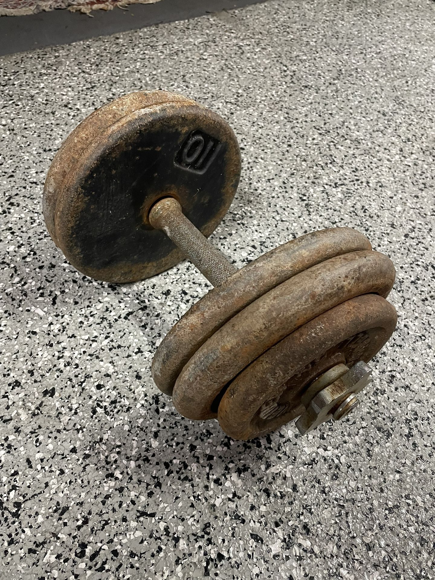 One Dumbbell With 50lbs Of Weight Plates