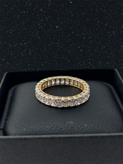 Radiant diamond eternity band in yellow gold
