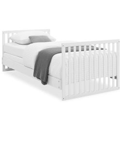 Mini crib with organic mattress and several girl fitted sheets