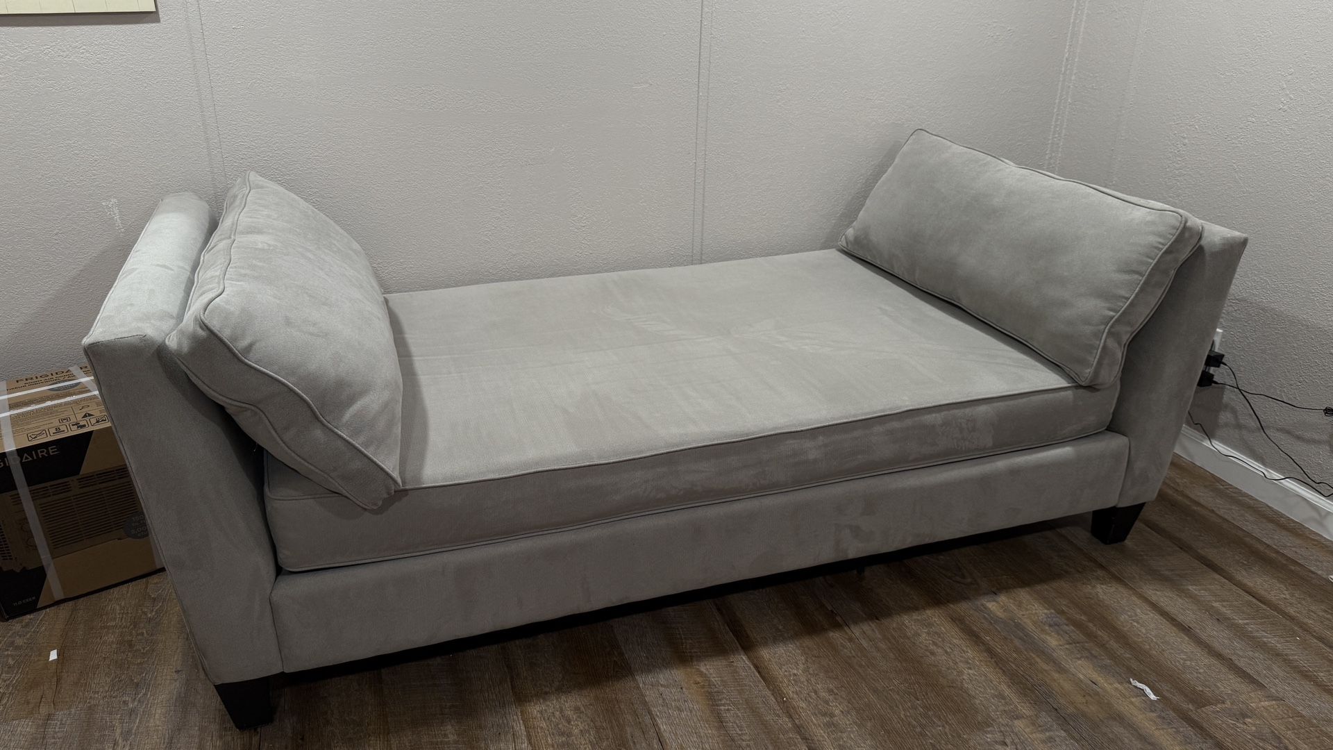 Living Spaces Grey Couch With Two Pillows