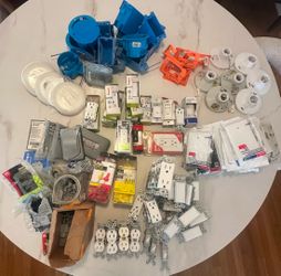 Box of various electronic items. Most of everything is new. Includes gfi plug, light switches, 3 way switches, occupancy sensors, covers, porcelain la