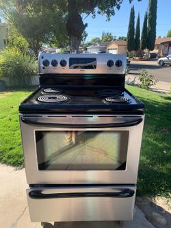 GE Stainless steel and black  electric range with 4 coil burners