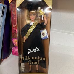 Millennium Grad Barbie Doll, a Special Edition release from Mattel in 2000.  The doll features a black graduation gown and cap with gold accents.  Acc