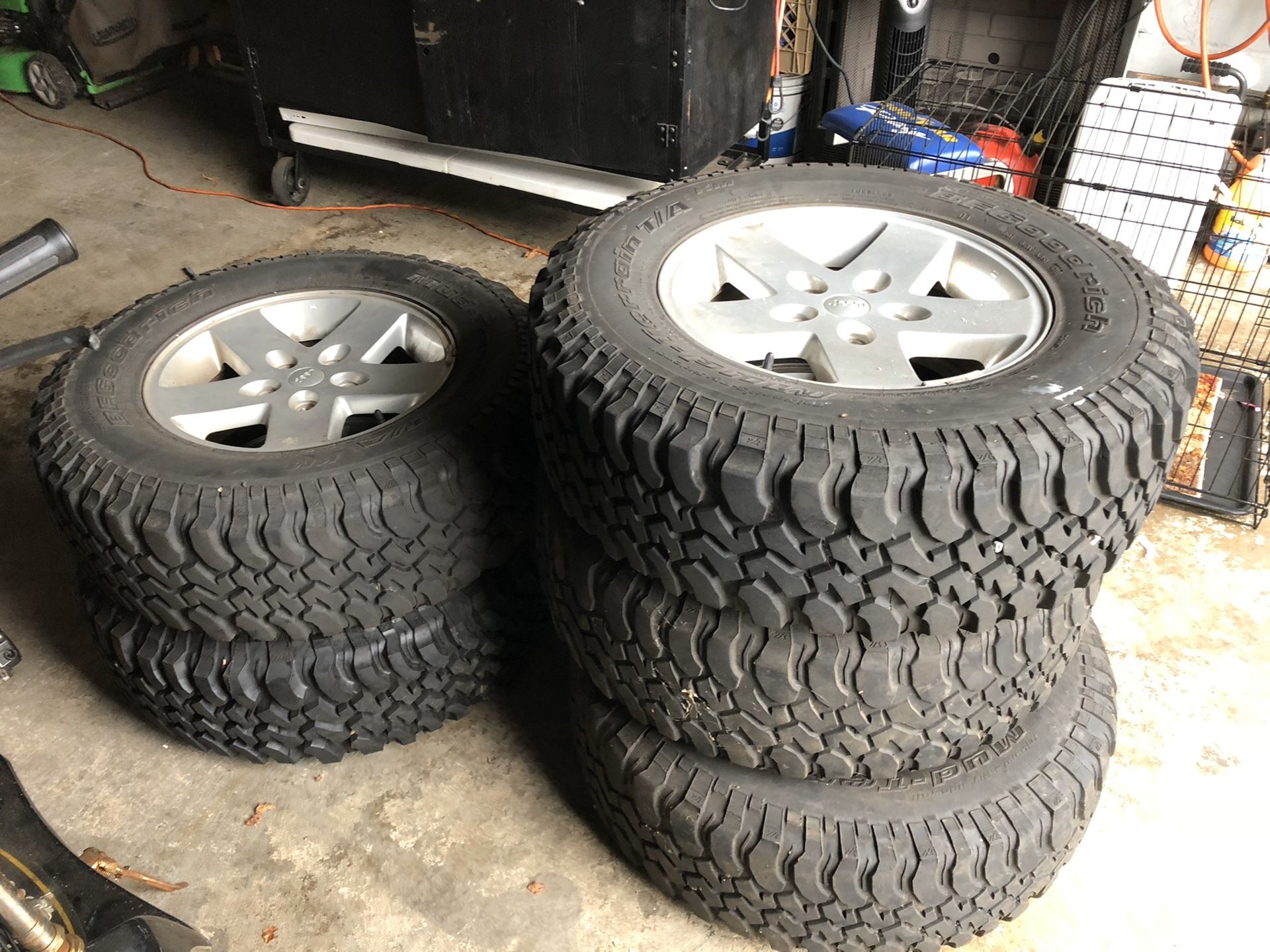 5 jeep tire and aluminum rims mud e snow one tire never used