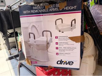 Raised toilet seat with handles