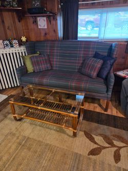 Queen Anne style wingback sofa with fabric upholstery and Teak wood coffee table