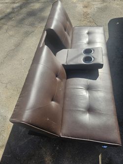 Adjustable leather futon with metal legs comparable to a twin matress