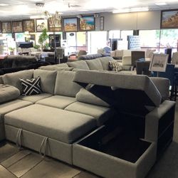 Beautiful Sectional With Pull Out Bed Storage And Cup Holders 